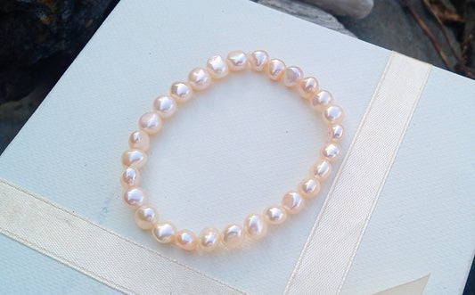 Jemný pružný náramek z pravých říčních perel ve světle lososové